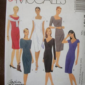 May include: An Easy McCall's sewing pattern envelope featuring illustrations of six different dress styles labeled A through F. The dresses include various necklines, sleeve lengths, and colors such as red, teal, white, black, gray, and purple.