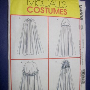 May include: A McCall's Costumes sewing pattern, M4698, featuring illustrations of capes with different styles. The pattern includes a cape with a collar, a hooded cape, and capes with ruffled details. The pattern is for sizes YY (Sml-Med).