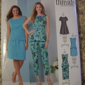 May include: Simplicity sewing pattern 1466 BB featuring two women modeling outfits. The pattern includes a sleeveless top and skirt, and a sleeveless top with pants. The outfits are in shades of blue and green. The text reads "Step by step to sewing success!"