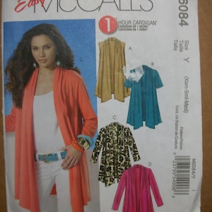 May include: A sewing pattern for a one-hour cardigan. The pattern includes four different styles: a sleeveless cardigan, a teal cardigan, a leopard print cardigan, and a pink cardigan. The pattern is for sizes X-Small, Small, and Medium.
