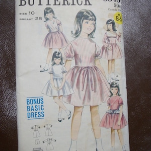 May include: Vintage Butterick sewing pattern, size 10, featuring illustrations of girls in various dresses. The pattern includes a bonus basic dress design. The cover displays the text "BUTTERICK" and "BONUS BASIC DRESS".