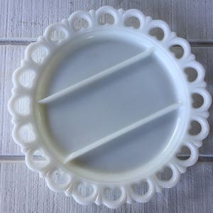 May include: White milk glass divided serving dish with a scalloped edge.