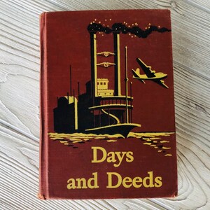 May include: A vintage red hardcover book with a black and yellow illustration of a steamboat on the water with a plane flying overhead. The book title is "Days and Deeds".