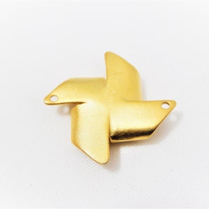 May include: Gold-colored metal windmill charm with two holes for attaching to jewelry or other crafts.