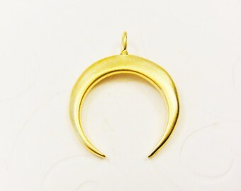 May include: A gold crescent moon pendant charm with a smooth, brushed finish. The pendant has a loop at the top for attaching to a necklace or bracelet.