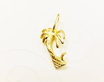 May include: A gold palm tree charm pendant. The palm tree is detailed with a textured trunk and leaves.