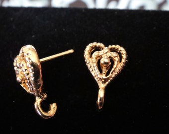 May include: Two gold-tone earring findings with a heart-shaped design. One finding has a loop at the bottom and the other has a post.