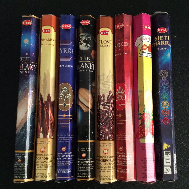 May include: A set of ten incense sticks with colorful packaging. The packaging features images of planets, stars, flowers, and a clove. The packaging also includes the text "HEM" and "INCENSE".