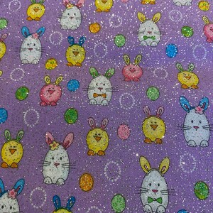 May include: Purple fabric with a repeating pattern of white bunnies with green bows, yellow chicks, and colorful polka dots.