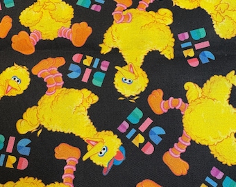 May include: Black fabric with a repeating pattern of yellow Big Bird characters and the words "Big Bird" in rainbow colors.