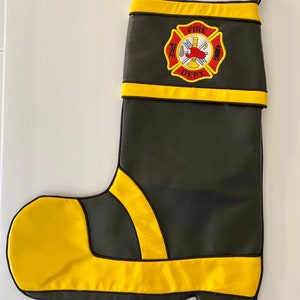 May include: Black leather stocking with yellow trim and a red, white, and black fire department emblem that says "Fire Dept."