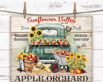 Può includere: Un cartello in legno rustico con la scritta "Sunflower Valley" e "Apple Orchard". Un camioncino verde vintage è pieno di mele e girasoli. Sono presenti anche una carriola, un barile di legno e piante in vaso.
