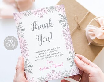 May include: A rectangular thank you card featuring a border of silver and pink glittery snowflakes. The text reads: Thank You! You brought joy to our day, warmth to our lives, and happiness to our hearts. Thank you for your special gift! Love, Sophia & Michael.