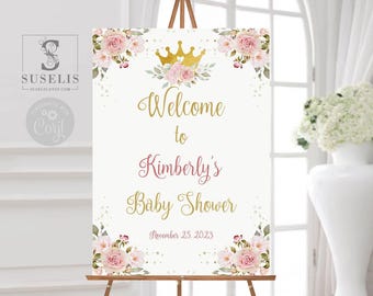 Puede incluir: Un letrero de bienvenida rectangular para baby shower con rosas rosas, hojas verdes y una corona dorada. El texto Welcome to Kimberly's Baby Shower November 25, 2023 aparece en letras doradas y rosas sobre un fondo blanco.