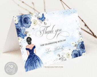 May include: A folded thank you card featuring a watercolor illustration of a person in a dark blue gown, surrounded by navy and white roses and blue butterflies. The text reads Thank you FOR CELEBRATING WITH US! Love, Kimberly.