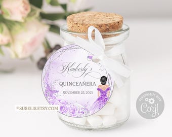 May include: A clear glass jar with a cork stopper filled with white candies. A round purple and white tag is tied to the jar with a white ribbon, featuring the text Kimberly's QUINCEAÑERA NOVEMBER 25, 2021, a butterfly, roses, and an illustration of a person in a purple dress.