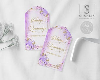 May include: Two rectangular paper tags with rounded tops featuring a light purple watercolor background, gold geometric borders, and floral accents in shades of purple and gold. The text reads Valentina's Quinceañera November 25, 2023.