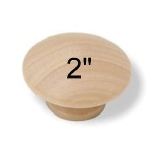 May include: A light-colored wooden knob with a rounded top and a smaller base. The number "2" is printed in black on the top of the knob, indicating a 2-inch diameter. The knob is likely for furniture or cabinetry.