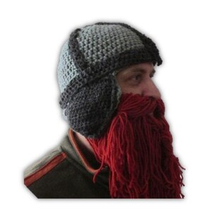 May include: A gray and black crocheted hat with ear flaps and a long, red crocheted beard attached.