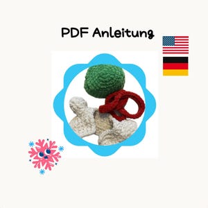 May include: PDF instructions for crocheting a green ball, two white crocheted bone shapes, and a red crocheted ring. The instructions are in German and include the text "PDF Anleitung".