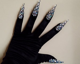 May include: Black satin gloves with long, pointed, iridescent blue and silver nail tips.