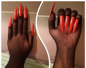 May include: A pair of black sheer gloves with long, bright red, pointed fingernails.