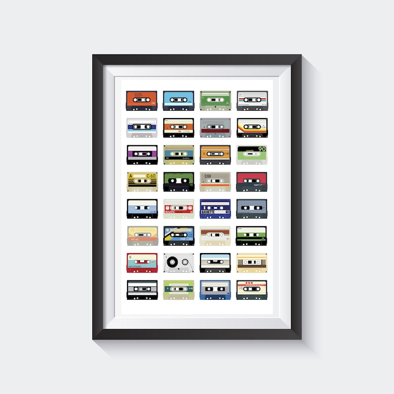 May include: A framed print featuring a grid of colorful cassette tapes. The tapes are in various colors, including orange, blue, green, and red, with labels and details. The artwork is set against a white background, framed in black.
