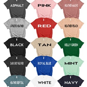 May include: Color chart showing 12 different t-shirt colors. The colors are: Asphalt, Pink, Heather Mauve, Athletic Heather, Red, Heather Peach, Black, Tan, Kelly Green, Dark Grey Heather, Royal Blue, Mint, Heather Deep Teal, White, and Navy.