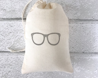 May include: A small, white cotton drawstring bag with a gray outline of eyeglasses printed on the front.
