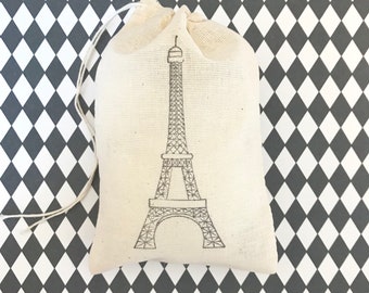 May include: A white cotton drawstring bag with a black outline drawing of the Eiffel Tower.