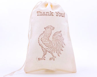 May include: A white cotton drawstring bag with a brown rooster illustration and the text "Thank You!" printed on the front.