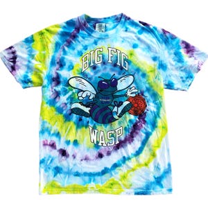 May include: Tie-dye t-shirt with a cartoon wasp graphic. The shirt features a swirling pattern of blue, yellow, and purple. The graphic includes the words "BIG FIG" above the wasp and "WASP" below.