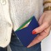 Cobalt blue card holders and green metallic leather details