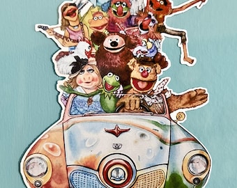 May include: A colorful vintage car with a group of Muppet characters riding inside. The car is painted in a variety of colors, including red, yellow, blue, and green. The Muppets are all smiling and waving. The car has a white bumper and a chrome grill.