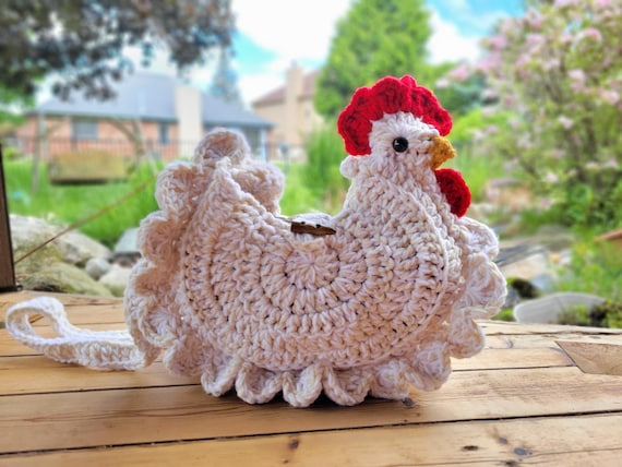 A fully crocheted chicken you wear as a crossbody bag — 1,585 favorites don't lie, this is a genuine viral handmade hit.