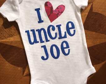 Personalized and appliqued I heart my uncle onesie in blue and red fabrics