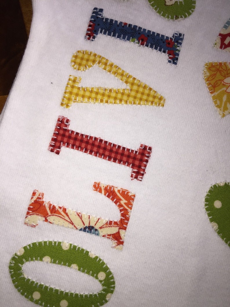Personalized appliqu\u00e9d patchwork flower baby onesie