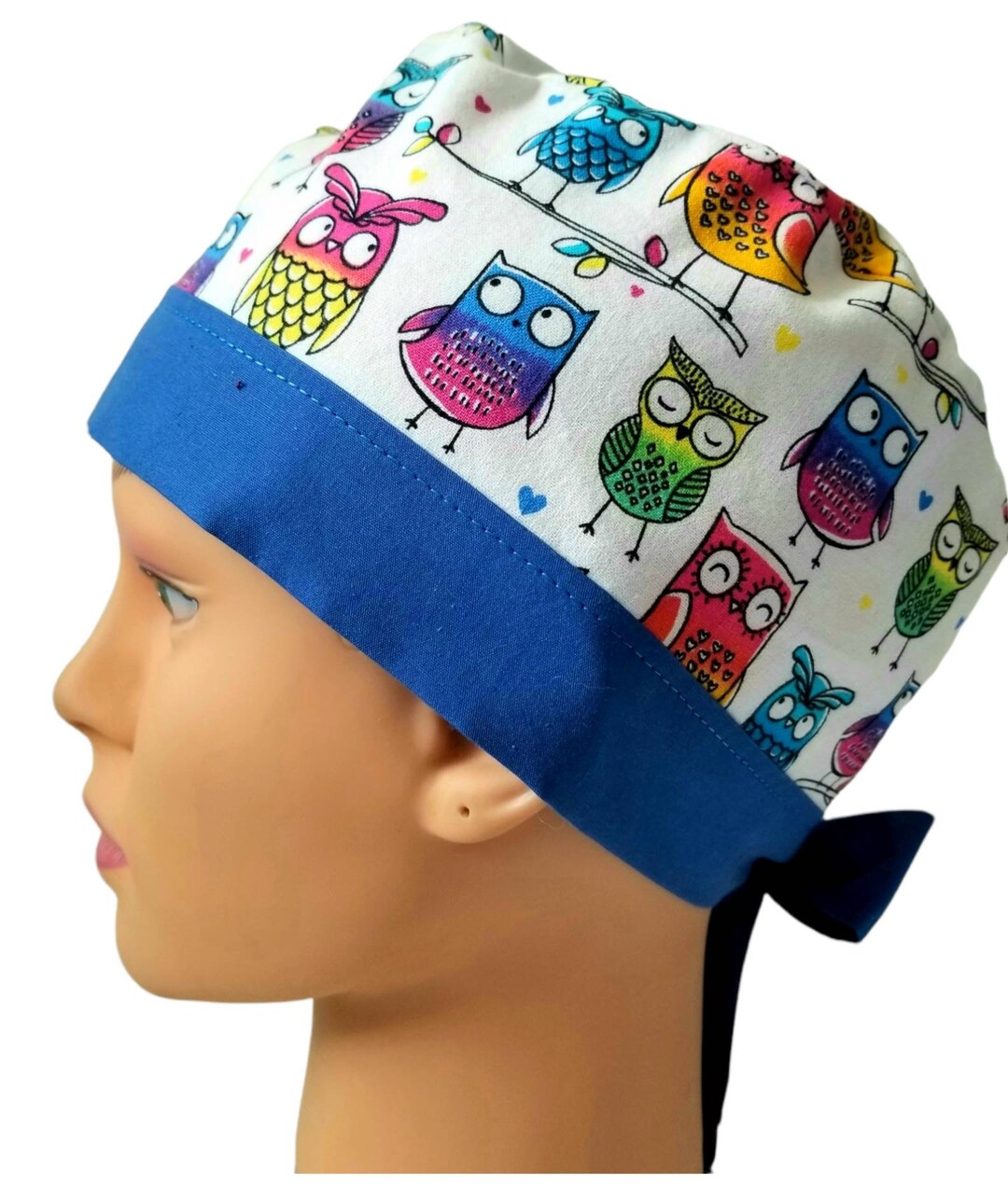 Womens fitted owl scrub cap. Multi colored owls on white background