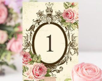 May include: A vintage-style table number card with a floral design. The card features a large, ornate frame with a number "1" in the center. The frame is surrounded by pink roses and green leaves.
