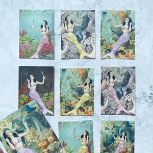 May include: Nine vintage postcards featuring mermaids in various poses with a seashell in their hand. The mermaids are surrounded by colorful coral, seaweed, and other sea life. The postcards are in good condition with some minor wear and tear.