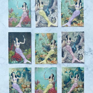 May include: Nine vintage postcards featuring illustrations of mermaids with colorful tails and seashells. Each postcard has a different background with coral, seaweed, and other ocean life.