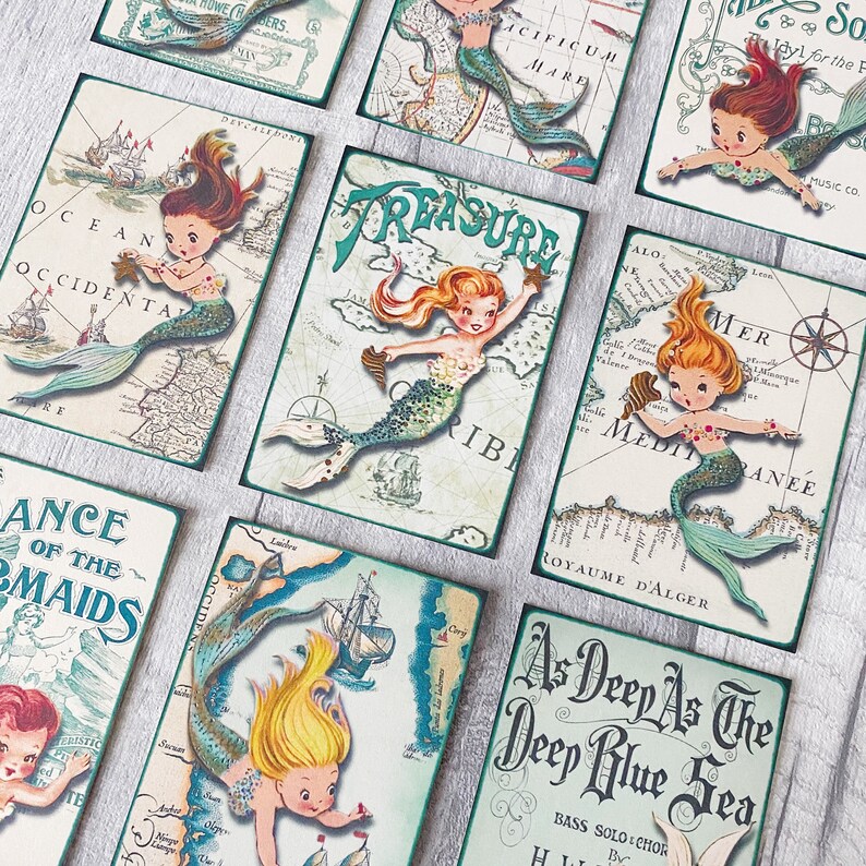 May include: A set of nine vintage-style cards featuring mermaids and nautical maps. Each card has a different mermaid design and a map background with text like "Treasure", "Ocean Occidental", and "As Deep As The Deep Blue Sea".