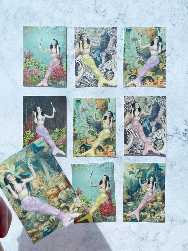 May include: Nine vintage postcards featuring mermaids in various poses with a seashell in their hand. The mermaids are surrounded by colorful coral, seaweed, and other sea life. The postcards are in good condition with some minor wear and tear.