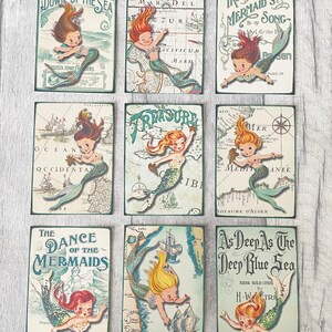 May include: Nine vintage cards featuring illustrations of mermaids with a nautical theme. The cards feature maps, text, and illustrations of mermaids with long flowing hair and tails. The cards are printed on a white background with green and blue accents.