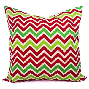 May include: Red and green chevron patterned throw pillow. The pillow is made of a soft, comfortable fabric and is perfect for adding a touch of holiday cheer to your home.