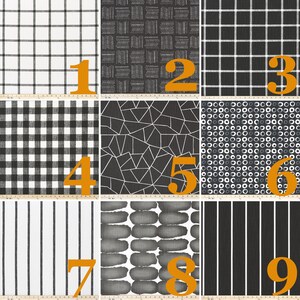May include: A collection of nine fabric swatches featuring black and white patterns including grids, geometric shapes, circles, and stripes. Each swatch is numbered 1 through 9, with a visible ruler at the bottom showing measurements in centimetres.