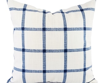 May include: A white pillow with a blue and white plaid pattern.