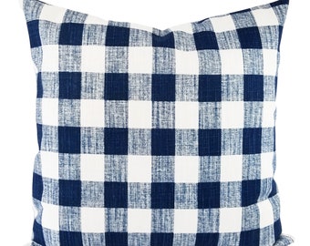 May include: A navy blue and white checkered throw pillow with a soft, textured fabric.