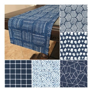 May include: Set of six blue and white table runners with different geometric patterns. The patterns include a grid, dots, stripes, and abstract shapes.