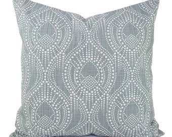 May include: A gray throw pillow with a white geometric pattern of dots and circles.